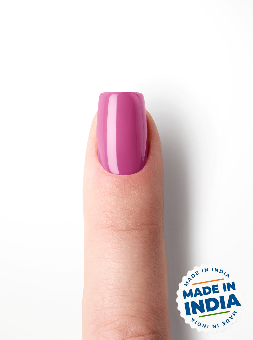 Finger with pink nail art on a white background with 'Made in India' label