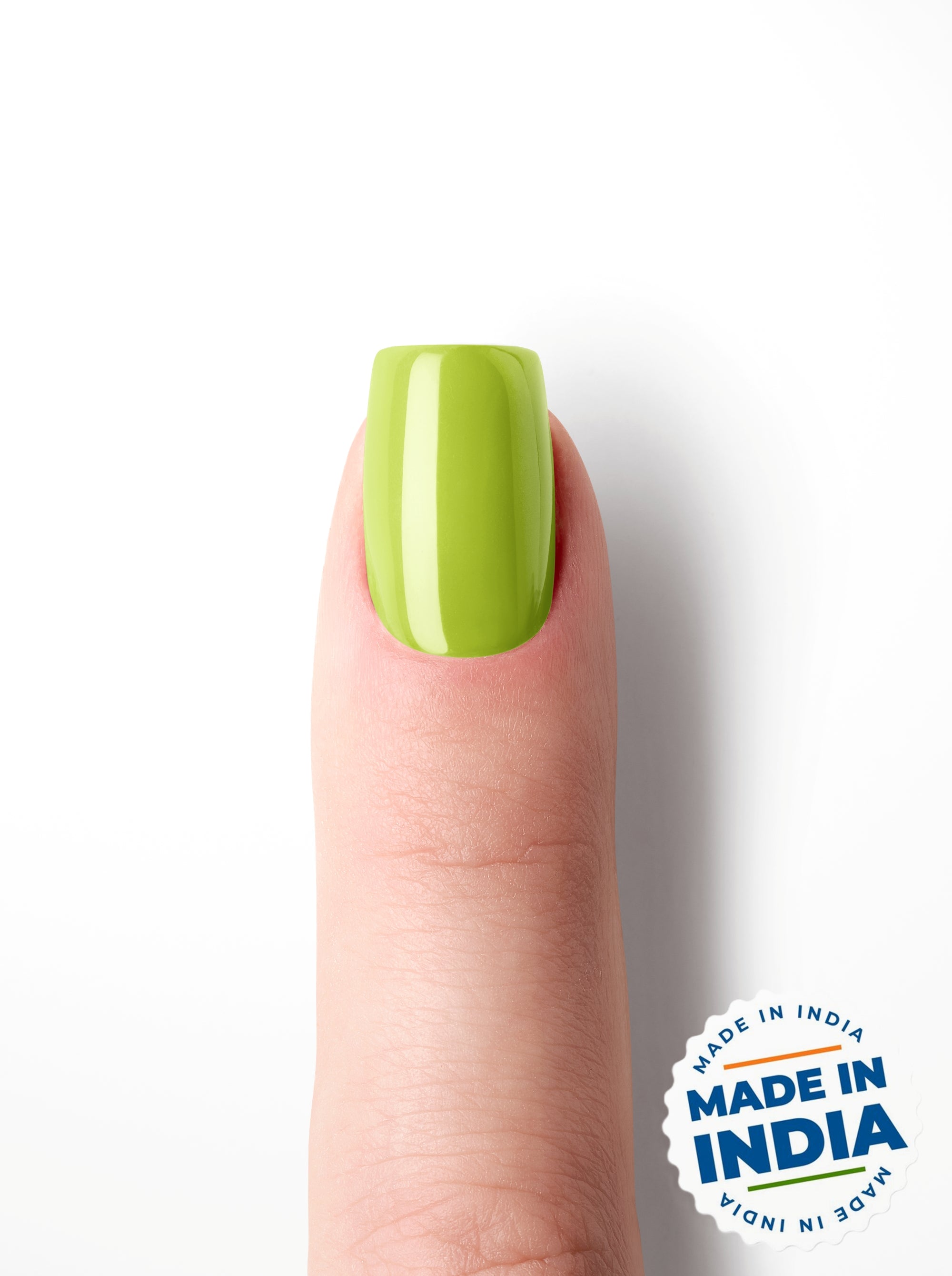Green nail polish on a finger with 'Made in India' label