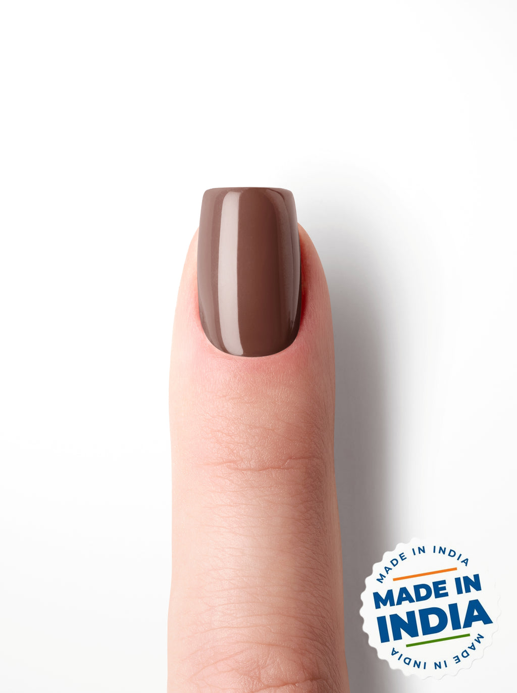 Nail with brown polish on a white background with 'Made in India' label