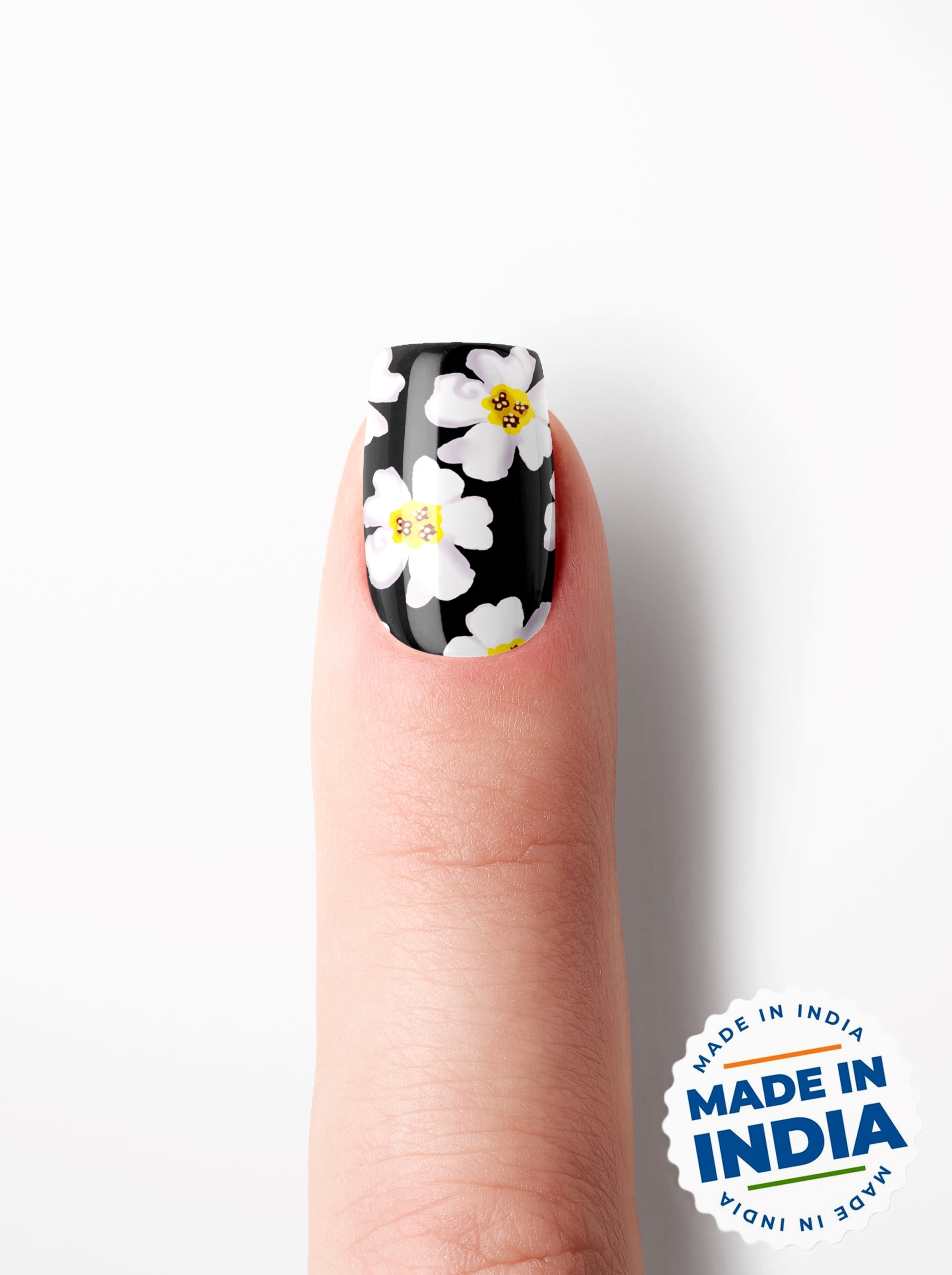 Nail with black and white floral design on a white background, featuring 'Made in India' label.