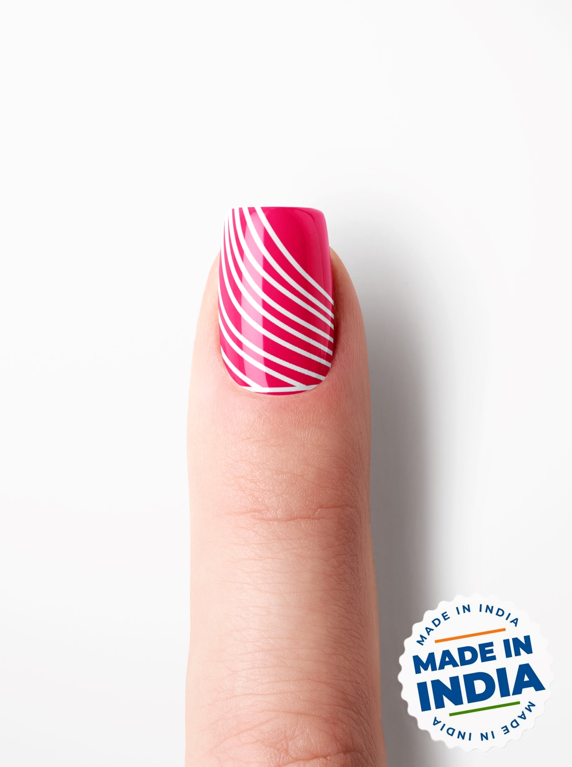 Finger with pink nail polish and white stripes on a white background with 'Made in India' label.