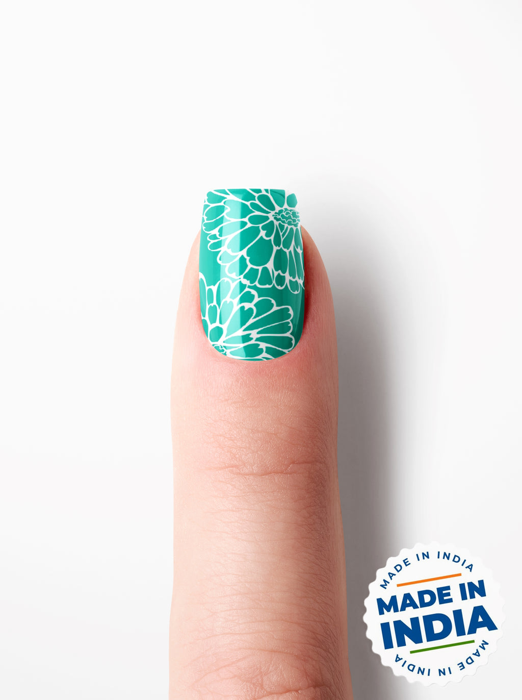Nail with green floral design on a white background with 'Made in India' label.