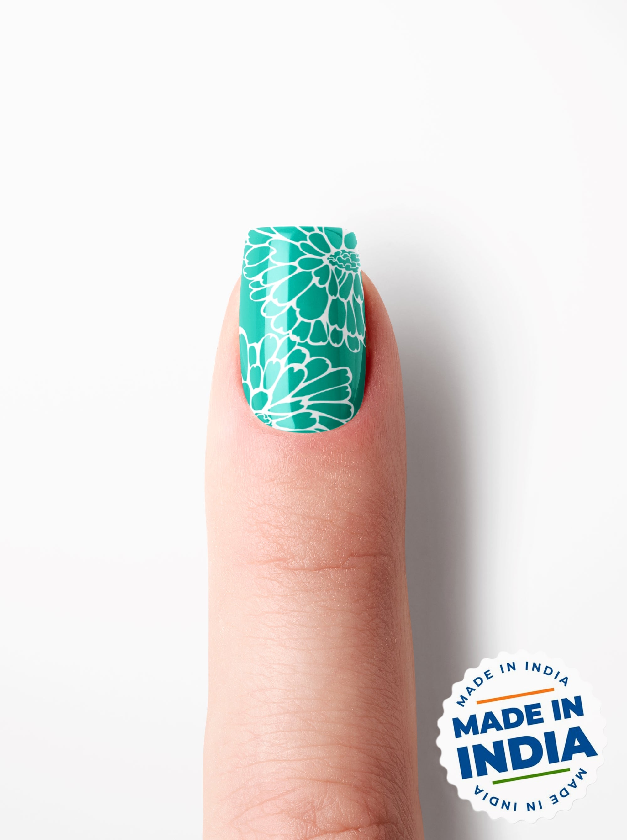 Nail with green floral design on a white background with 'Made in India' label.
